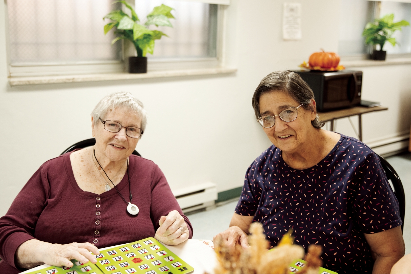 Two women sitting at a table reading